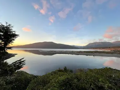 a view of a river at sunset at Hot tub - Sauna - Panoramic Ocean View THE POINT - Pet Friendly in Port Renfrew