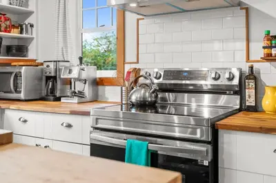 a kitchen with a stainless steel stove top oven at Hot tub - Sauna - Panoramic Ocean View THE POINT - Pet Friendly in Port Renfrew