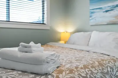 a pile of towels sitting on top of a bed at Oceanview - Pet Friendly - Gas Fireplace - Wild Beauty in Port Renfrew