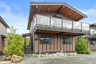 a modern house with a glass facade at Oceanview - Pet Friendly - Gas Fireplace - Wild Beauty in Port Renfrew