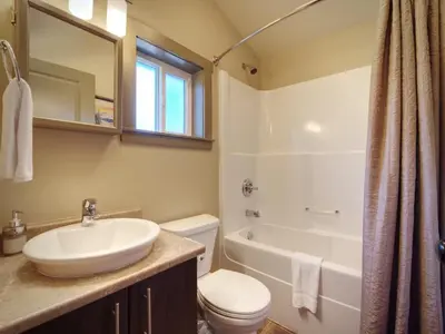 a bathroom with a sink and a toilet and a tub at Explorers Retreat Private Sauna - Pet Friendly in Port Renfrew