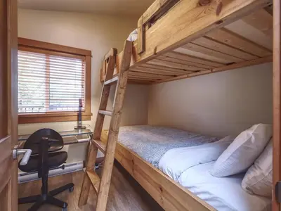a bunk bed with a desk and a chair in a room at Going Coastal A - Oceanfront - Pet Friendly in Port Renfrew