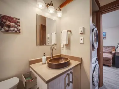a bathroom with a sink and a toilet at Going Coastal A - Oceanfront - Pet Friendly in Port Renfrew