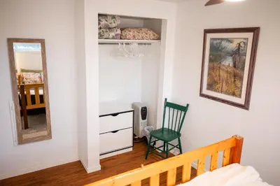 a bedroom with a bed and a desk and a chair at Spacious 2-Bedroom Basement Suite in Whitehorn, Close to Calgary Airport, Hospital, & Train in Calgary