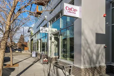 a store with a bench in front of a building at Family Condo w Kids Den FREE Banff Pass in Calgary