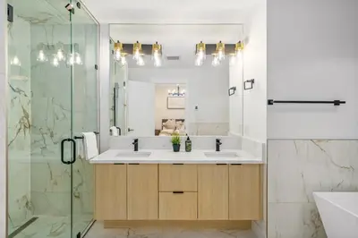 a bathroom with a sink and a mirror at Trendy Bridgeland, Fireplace, King Beds, AC in Calgary