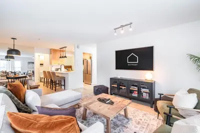 a living room with a fireplace and a tv at Wintergreen 26 by Outpost Whistler in Whistler