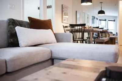 a living room with a couch and a dining room at Wintergreen 26 by Outpost Whistler in Whistler
