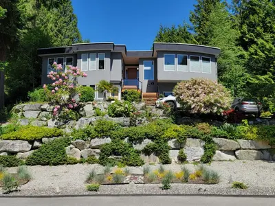 a house with a garden in front of it at Modern Coastal 2BR Retreat with Private Hot Tub in Vancouver BC in West Vancouver