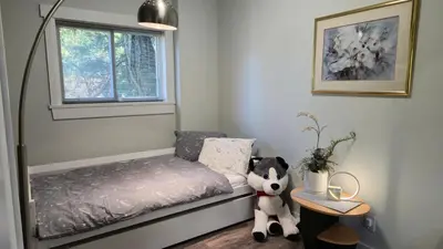 a small bedroom with a bed and a stuffed animal at Modern Coastal 2BR Retreat with Private Hot Tub in Vancouver BC in West Vancouver
