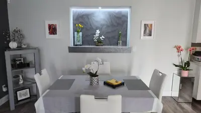 a dining room with a table and chairs and a window at Modern Coastal 2BR Retreat with Private Hot Tub in Vancouver BC in West Vancouver