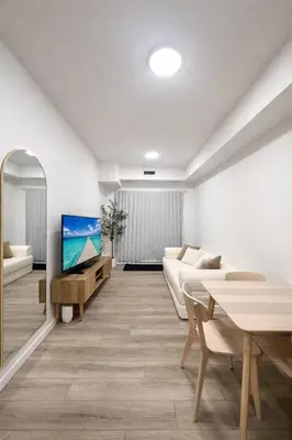 a living room with a couch and a tv at Condo w 2 Beds 13 Mins from West Edmonton Mall in Edmonton