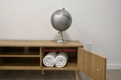 a book shelf with a globe and two towels at Condo w 2 Beds 13 Mins from West Edmonton Mall in Edmonton