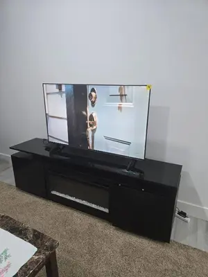 a black dresser with a fish tank on it at Cy Becker Drive 2023 Luxury Home in Edmonton