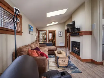 a living room with a couch and a fireplace at Going Coastal ABC - Oceanfront - Pet Friendly in Port Renfrew