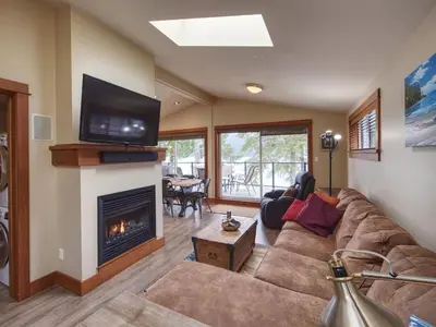 a living room with a couch and a fireplace at Going Coastal ABC - Oceanfront - Pet Friendly in Port Renfrew