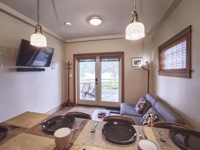 a living room with a table and a couch at Going Coastal AB - Oceanfront - Pet Friendly in Port Renfrew