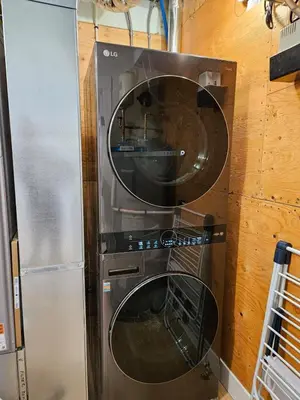 a washer and dryer sitting in a wall at Hot Tub - Sleep 12 - EV Charger J1772 - Forest View - Pet Friendly in Mount Washington