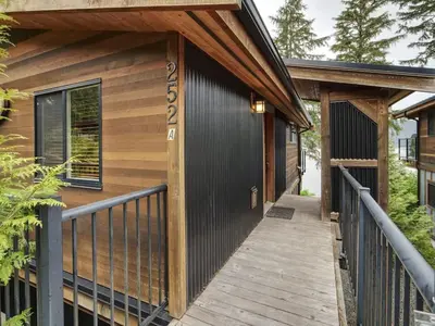 a wooden walkway leading to a building with a porch at Oceanfront view - Pet Friendly - Sleep 8 in Port Renfrew