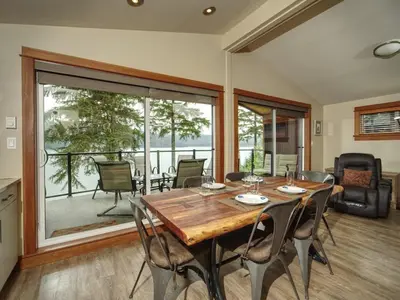 a dining room with a wooden table and chairs at Oceanfront view - Pet Friendly - Sleep 8 in Port Renfrew