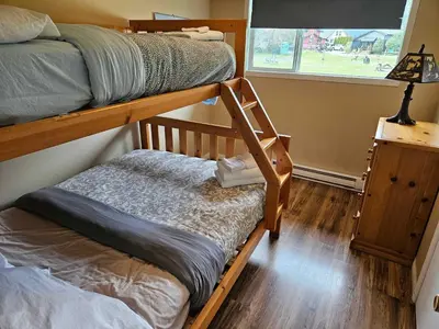 a bedroom with two bunk beds and a window at The Outfitter - Garden View - Pet Friendly - Huge yard in Port Renfrew