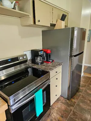 a kitchen with a stove and a refrigerator at The Outfitter - Garden View - Pet Friendly - Huge yard in Port Renfrew