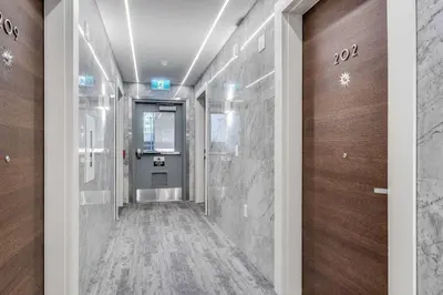 a hallway of a building with a door with numbers on it at Prime West End 2BR- Central Vancouver Lifestyle in Vancouver