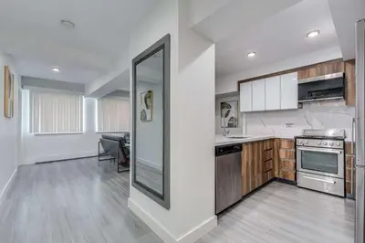 a kitchen with white walls and a large mirror at Prime West End 2BR- Central Vancouver Lifestyle in Vancouver