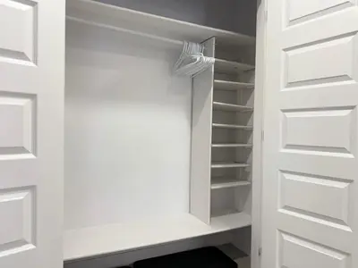 a walk in closet with white doors at Family Friendly GarageFireplace Sleeps 8 in Edmonton
