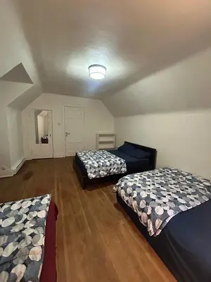 a room with two beds and a ceiling at Vancouver Budget Stay - Airport 10 Min - Free Parking & Fast WiFi in Vancouver