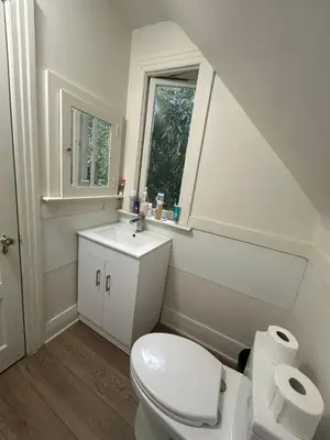 a bathroom with a toilet and a sink and a window at Budget Vancouver Stay - Airport & Downtown 10 & 15 Min, Free Parking & Fast Wifi in Vancouver