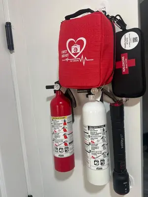 a wall with fire extinguishers and a bag on top at Family-Friendly Home in the Heart of Chestermere in Chestermere