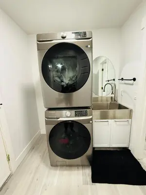 a microwave sitting on top of a stove in a kitchen at Family-Friendly Home in the Heart of Chestermere in Chestermere