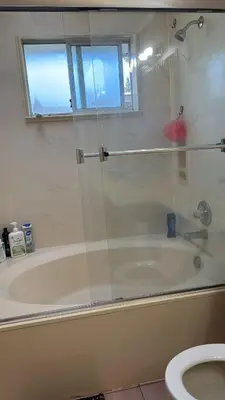 a bathroom with a shower and a tub and a toilet at North Delta Budget Stay - Scott Road - Free Parking & Fast WiFi in Delta
