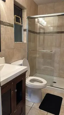 a bathroom with a toilet and a sink and a shower at North Delta Budget Stay - Scott Road - Free Parking & Fast WiFi in Delta
