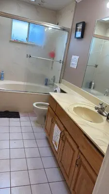 a bathroom with a sink and a tub and a toilet at Budget Stay Near Scott Road - Transit, Free Parking & Fast WiFi in Delta