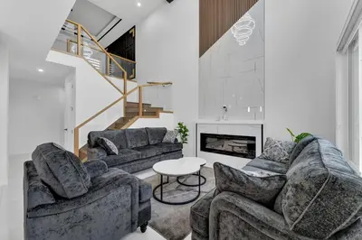a living room with two couches and a fireplace at 3 Bedrooms Brand New Luxury Home Close to Amenity in Leduc