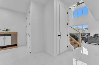 a white living room with a couch and a table at 3 Bedrooms Brand New Luxury Home Close to Amenity in Leduc