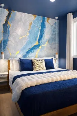 a bedroom with a large painting on the wall at Ocean-Inspired Art Suite in Langford