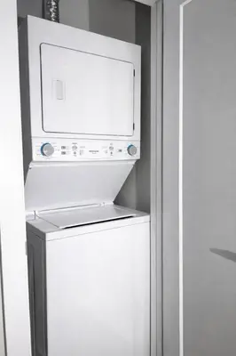 a white refrigerator with a microwave on top of it at Ocean-Inspired Art Suite in Langford