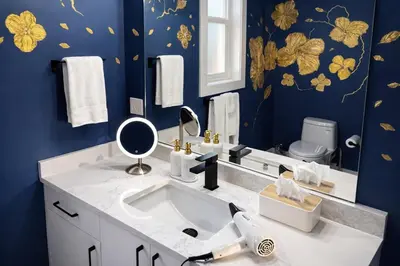 a bathroom with a sink and a mirror at Ocean-Inspired Art Suite in Langford