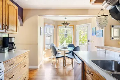 a kitchen with a table and chairs in a kitchen at Harmony House short term rental in Okotoks