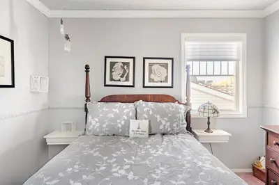 a bedroom with a bed and a window at Harmony House short term rental in Okotoks