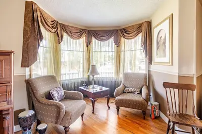 a living room with two chairs and a table at Harmony House short term rental in Okotoks