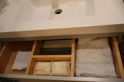 a bathroom sink with two pillows under a sink at Cozy and Private Guest Suite in West Edmonton in Edmonton