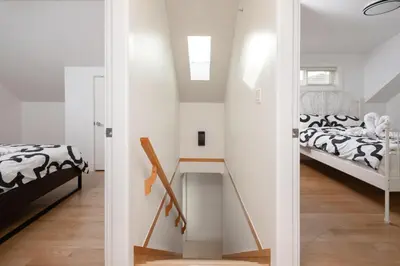 a bedroom with two beds and a table in a room at Private 2BR 2Bath Suite - Sunset Vancouver in Vancouver