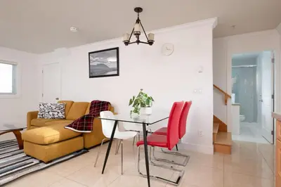 a living room with a table and a couch at Private 2BR 2Bath Suite - Sunset Vancouver in Vancouver