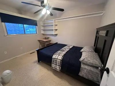 a bedroom with a bed and a ceiling fan at 3 Private rooms with built-in closet & desk in Edmonton