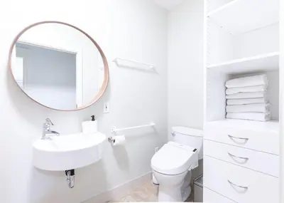 a white bathroom with a sink and a mirror at 3Beds Ground-Level Private Suite in Burnaby in Burnaby