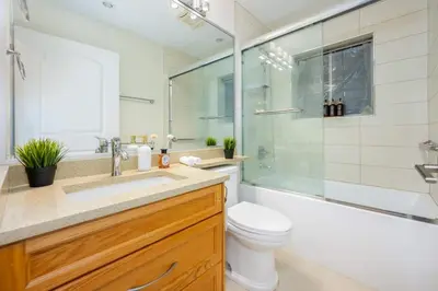 a bathroom with a sink and a toilet and a shower at Central Van 3BR Upper Suite - Near Skytrain in Vancouver